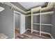 Walk-in closet providing built-in shelving and rods, as well as access to the bathroom at 761 N Holmes Ave, Indianapolis, IN 46222