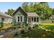 Charming home with well-maintained landscaping, green siding and inviting pathway to the front door at 761 N Holmes Ave, Indianapolis, IN 46222
