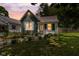 Charming home with well-maintained landscaping, green siding and inviting pathway to the front door at 761 N Holmes Ave, Indianapolis, IN 46222