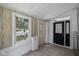 Covered front porch offering tile flooring and a side door for convenient access at 761 N Holmes Ave, Indianapolis, IN 46222