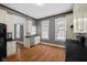 Kitchen featuring gray walls, wood floor, and white cabinets and trim plus stainless dishwasher and dual sink at 761 N Holmes Ave, Indianapolis, IN 46222