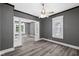 Living room featuring wood floors, gray walls, ceiling fan, and an open layout to adjoining rooms at 761 N Holmes Ave, Indianapolis, IN 46222