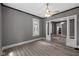 Spacious living room with modern floors, gray walls, and an open layout to the adjoining room at 761 N Holmes Ave, Indianapolis, IN 46222