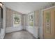 Bright sun room with tile flooring, white brick accents, and natural light through several windows at 761 N Holmes Ave, Indianapolis, IN 46222