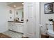 Charming bathroom features a granite countertop, white cabinetry, decorative accents, and gold hardware at 7612 Farm View E Cir, Indianapolis, IN 46256
