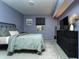 Cozy bedroom with a black metal bed frame, soft green bedding, and carpet flooring at 7612 Farm View E Cir, Indianapolis, IN 46256
