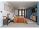 Spacious primary bedroom with a large bed, side tables, wood accents, and a modern TV at 7612 Farm View E Cir, Indianapolis, IN 46256