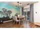 Bright dining area with wood floors, gray chairs, artistic wall decor and sliding door to the backyard at 7612 Farm View E Cir, Indianapolis, IN 46256