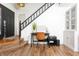 Entryway featuring wood flooring, black door, staircase and adjacent office nook at 7612 Farm View E Cir, Indianapolis, IN 46256