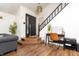 Entryway with wood floors, a black front door, and a staircase at 7612 Farm View E Cir, Indianapolis, IN 46256