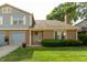 Charming home featuring mixed siding, brick, an attached two car garage and a neatly manicured lawn at 7612 Farm View E Cir, Indianapolis, IN 46256