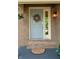 Front door close up with a wreath and exterior light fixture at 7612 Farm View E Cir, Indianapolis, IN 46256