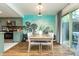 Well-lit kitchen area with stainless steel appliances, light-green cabinets, and wooden dining table at 7612 Farm View E Cir, Indianapolis, IN 46256