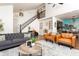 Spacious living room featuring a fireplace, staircase, and comfortable seating at 7612 Farm View E Cir, Indianapolis, IN 46256