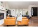 Living area featuring fireplace, hardwood floors, and large windows for abundant natural light at 7612 Farm View E Cir, Indianapolis, IN 46256
