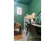 Cozy office nook with green walls, black desk, custom dog bed and artwork at 7612 Farm View E Cir, Indianapolis, IN 46256