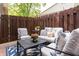 Cozy outdoor patio with comfortable seating, string lights, and a privacy fence perfect for relaxing at 7612 Farm View E Cir, Indianapolis, IN 46256