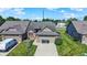 This aerial view shows the neighborhood street, the home's roof and attached garage at 785 Cottage Ln, Greenwood, IN 46143