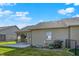 The backyard shows the home's siding, patio, flower bed, and black chain link fence at 785 Cottage Ln, Greenwood, IN 46143