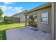 A concrete back patio with sliding glass doors overlooks a well-maintained lawn and fence at 785 Cottage Ln, Greenwood, IN 46143