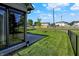 A spacious, fenced backyard is viewed from the home's rear corner with black chain link fence at 785 Cottage Ln, Greenwood, IN 46143