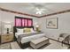 This bedroom features a decorative accent wall, complementing the natural light and stylish furnishings at 785 Cottage Ln, Greenwood, IN 46143
