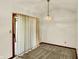 Dining room with vaulted ceiling, neutral carpet and light fixture, and sliding glass doors to the backyard at 785 Cottage Ln, Greenwood, IN 46143