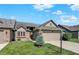 Attractive home exterior with a green lawn, mature tree, well maintained landscaping, and a large two-car garage at 785 Cottage Ln, Greenwood, IN 46143