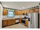 Kitchen featuring wooden cabinets, neutral counters, stainless steel appliances, and tile flooring at 785 Cottage Ln, Greenwood, IN 46143
