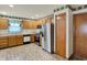 A cozy kitchen features tile floors, wooden cabinets, and modern stainless steel appliances at 785 Cottage Ln, Greenwood, IN 46143