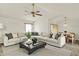 Bright living room featuring a large sectional sofa, modern coffee table, and stylish ceiling fan at 785 Cottage Ln, Greenwood, IN 46143