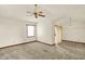 Empty living room featuring neutral carpet, ceiling fan, and sliding glass doors leading to outdoor space at 785 Cottage Ln, Greenwood, IN 46143