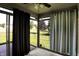 Bright sunroom with views of the landscaped yard, complemented by large windows and a ceiling fan at 785 Cottage Ln, Greenwood, IN 46143