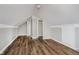 Finished attic space with hardwood floors, access to closet, and neutral paint at 8912 Robey Dr, Indianapolis, IN 46234