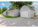 Backyard view of the house and detached garage with concrete driveway at 8912 Robey Dr, Indianapolis, IN 46234