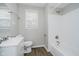 Cozy bathroom with shower-tub combo, tiled walls, and white vanity sink at 8912 Robey Dr, Indianapolis, IN 46234