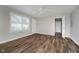 Bright bedroom with two entry doors, a ceiling fan, and wood-look floors at 8912 Robey Dr, Indianapolis, IN 46234