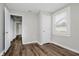 Neutral bedroom with closet and window, featuring modern, wood-look flooring at 8912 Robey Dr, Indianapolis, IN 46234