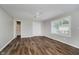 Spacious bedroom featuring wood-look floors, a ceiling fan, and a closet at 8912 Robey Dr, Indianapolis, IN 46234