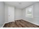 Well-lit bedroom with wood-look floors, a window, and a closet at 8912 Robey Dr, Indianapolis, IN 46234