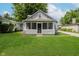 Charming bungalow-style home with a screened-in front porch and well-maintained lawn at 8912 Robey Dr, Indianapolis, IN 46234