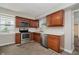 Updated kitchen with stainless steel appliances and wood cabinets at 8912 Robey Dr, Indianapolis, IN 46234