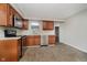 Modern kitchen with stainless steel appliances, wood cabinets, and hard surface countertops at 8912 Robey Dr, Indianapolis, IN 46234