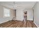 Bright living room showing view to kitchen, wood floors, and stairs at 8912 Robey Dr, Indianapolis, IN 46234