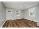Bright living room with wood floors, a ceiling fan, and a front door at 8912 Robey Dr, Indianapolis, IN 46234