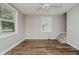 Bright living room with wood floors, and windows bringing natural light at 8912 Robey Dr, Indianapolis, IN 46234