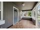 Inviting screened-in porch with tile flooring and a view of the front yard at 8912 Robey Dr, Indianapolis, IN 46234