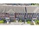 Aerial view of brick townhomes featuring well-manicured landscaping and covered entryways at 9476 Oakley Dr, Indianapolis, IN 46260