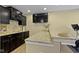 Finished basement bar area with granite countertops and black cabinets at 9476 Oakley Dr, Indianapolis, IN 46260