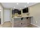 Finished bar with dark cabinets, countertop seating, and a TV at 9476 Oakley Dr, Indianapolis, IN 46260